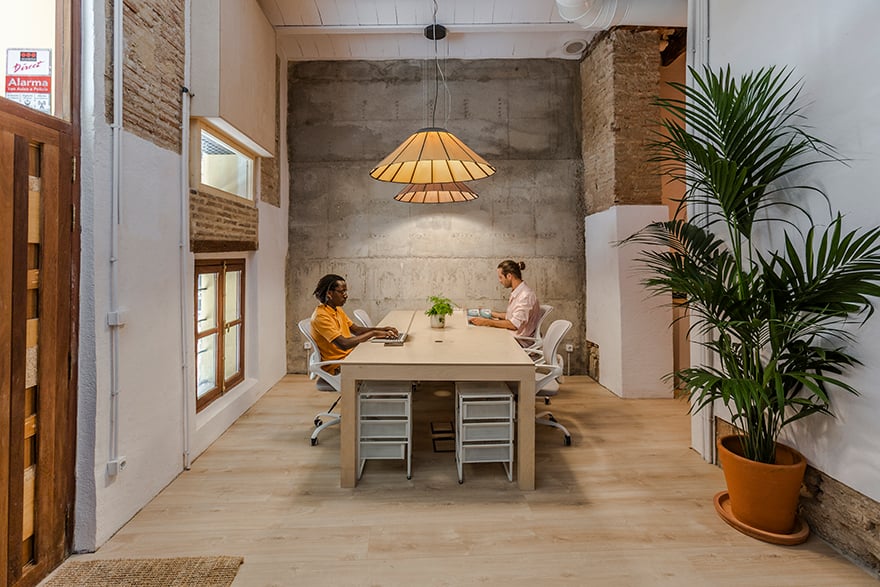 Co working space with people working and illuminated with LZF wooden lamps