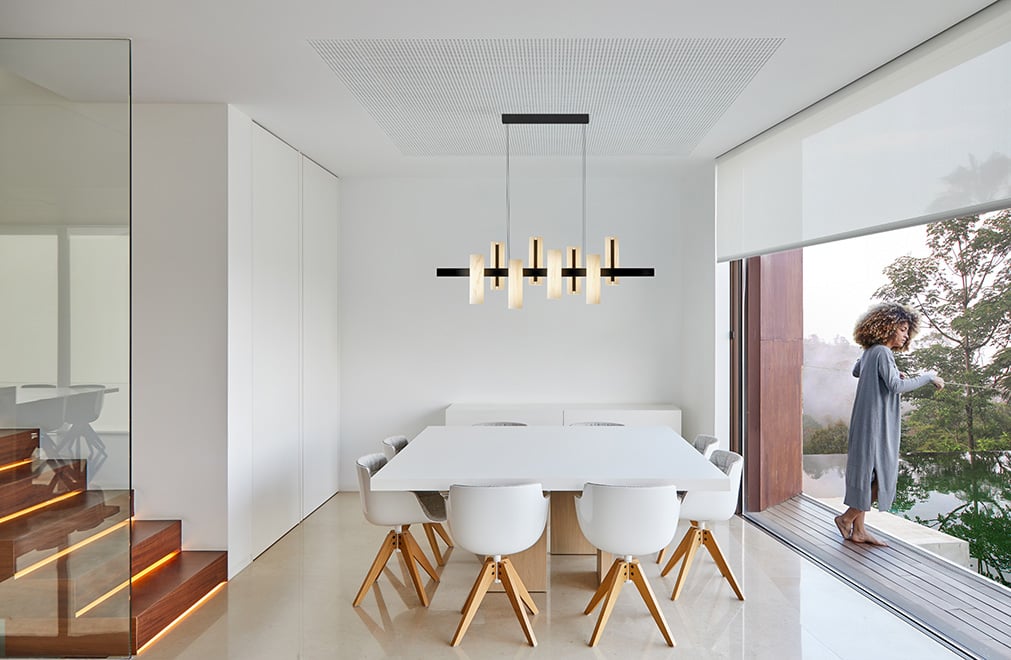 Black Note lamp by Lzf in white wood and black metal on the table of a modern living room