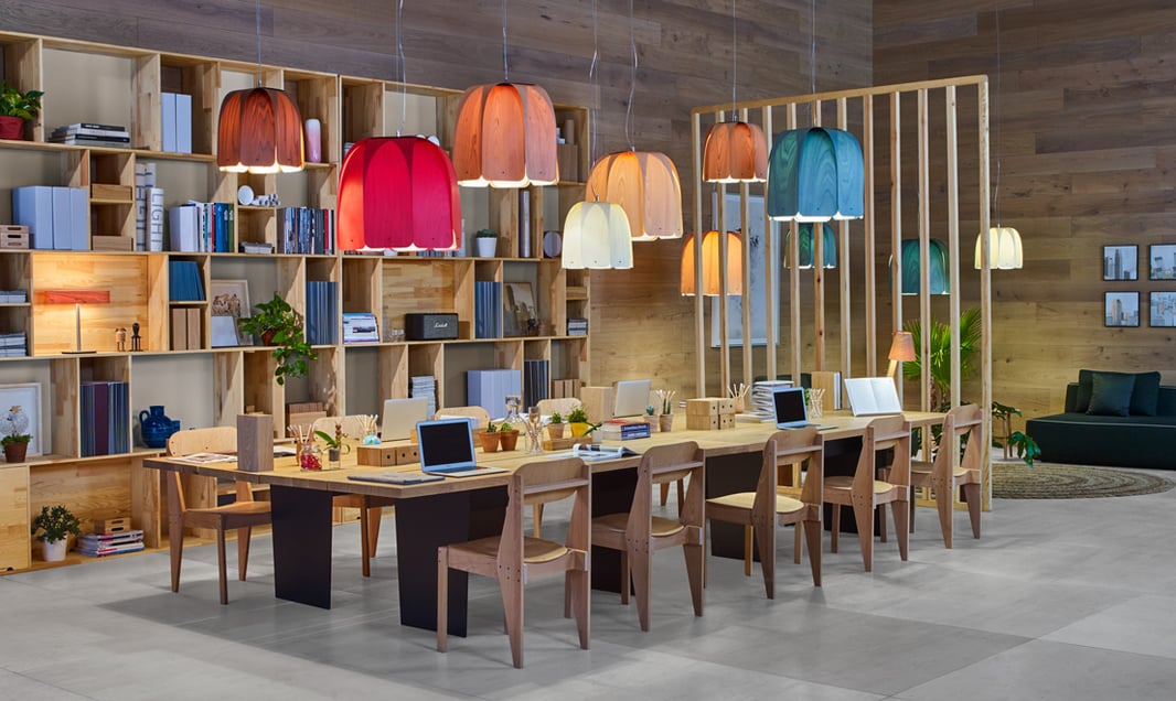 Composition of pendant lamps in various colors on a meeting table in an office