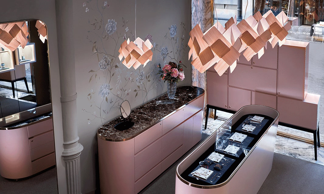 Pink wooden pendant lamps on the counter of a jewelry store