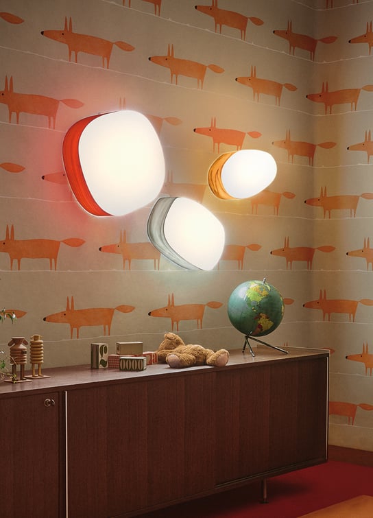 Detail of children's room with colored wooden sconces in the shape of pebbles
