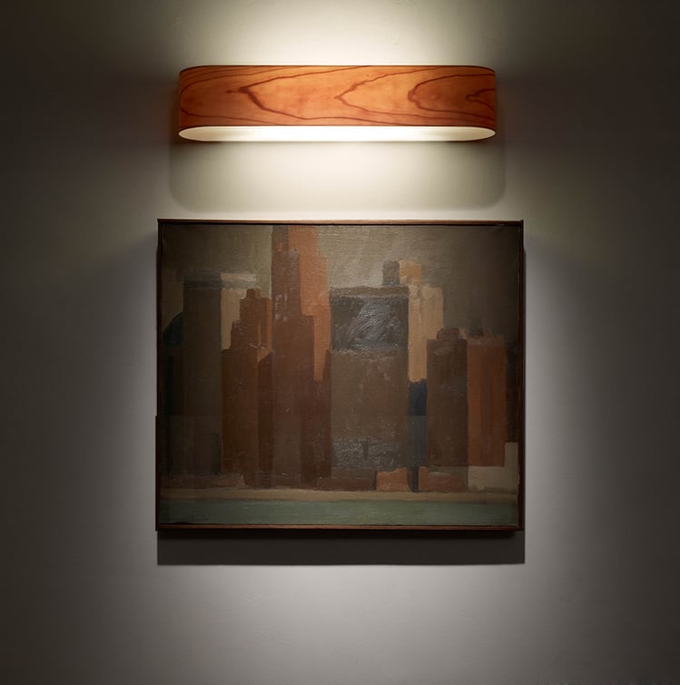 Detail of illuminated artwork with cherry wood wall light by LZF