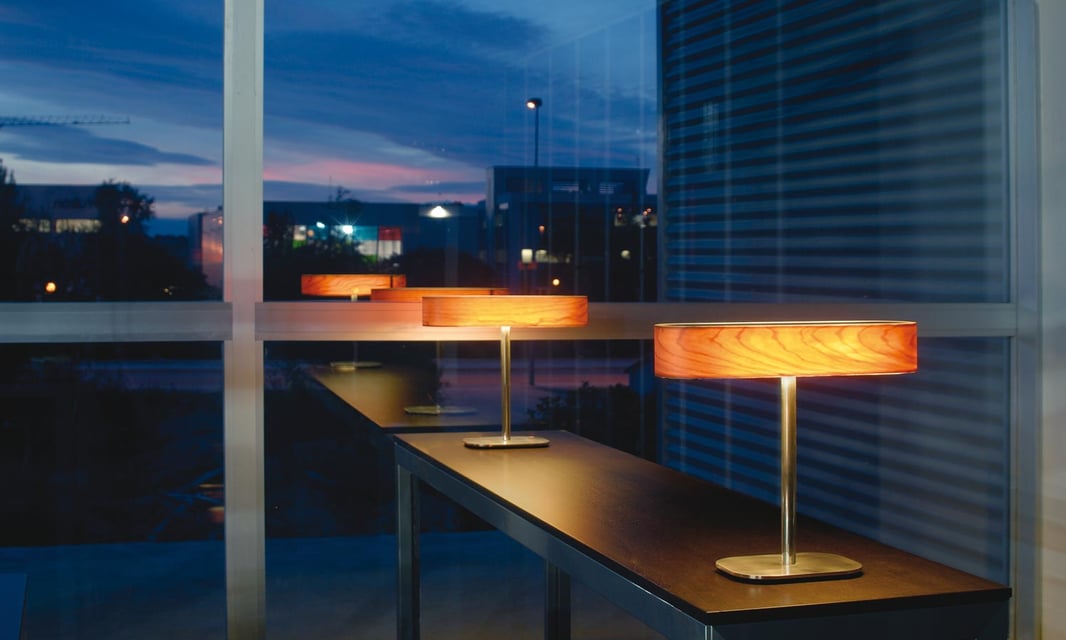 LZF table lamps with wooden diffuser and metal base in a company lobby