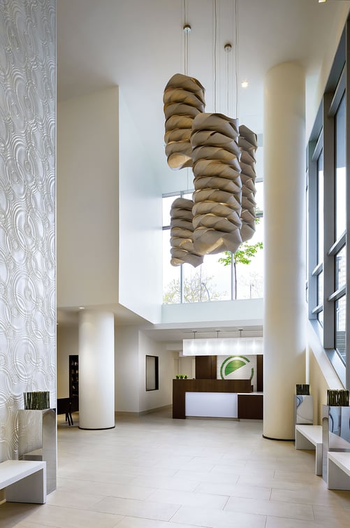 Hotel lobby illuminated with Möbius stacked veneer strip lamps
