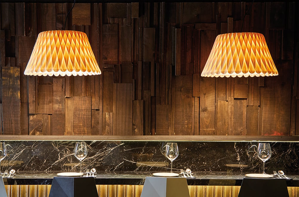 Restaurant bar area illuminated with geometric pattern lamps in LZF natural beech veneer