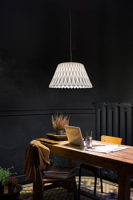 Study area illuminated by conical lamp with geometric pattern in natural wood veneer from LZF