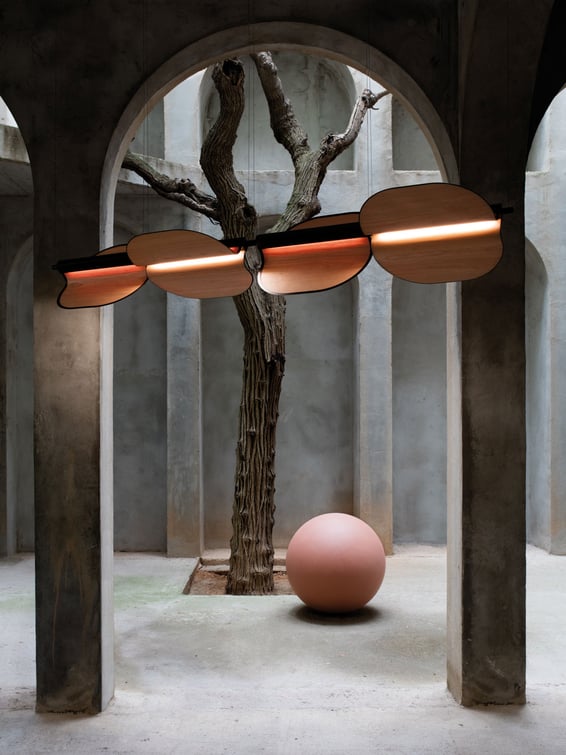 Architectural space with ingenious lamp made of wood and metal leaves