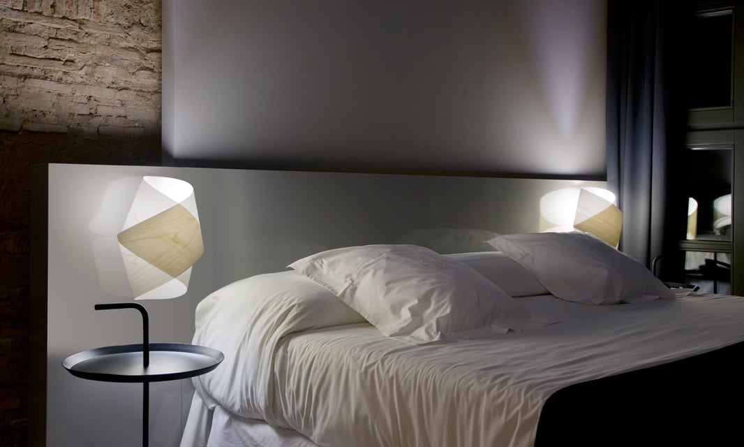 Bedroom illuminated in its headboard with handmade lamps by twisting a piece of wood veneer
