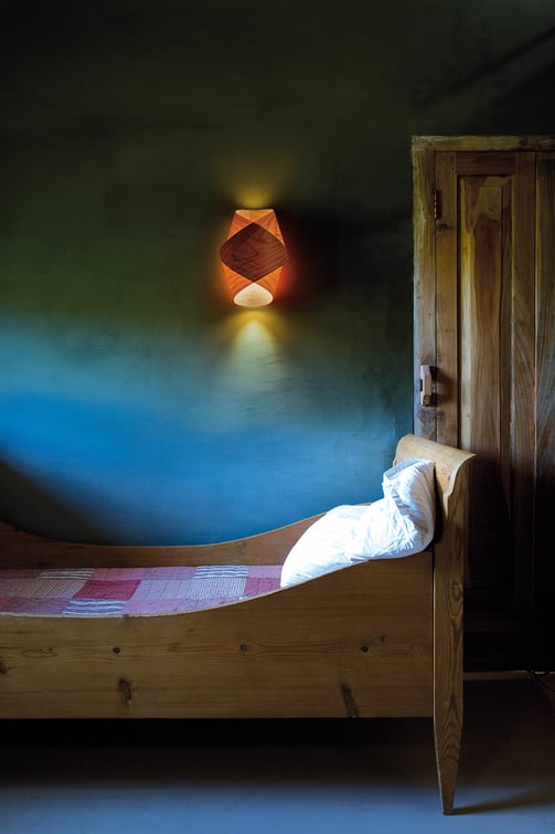 Rustic bedroom decorated with cherry wood veneered wall lamp