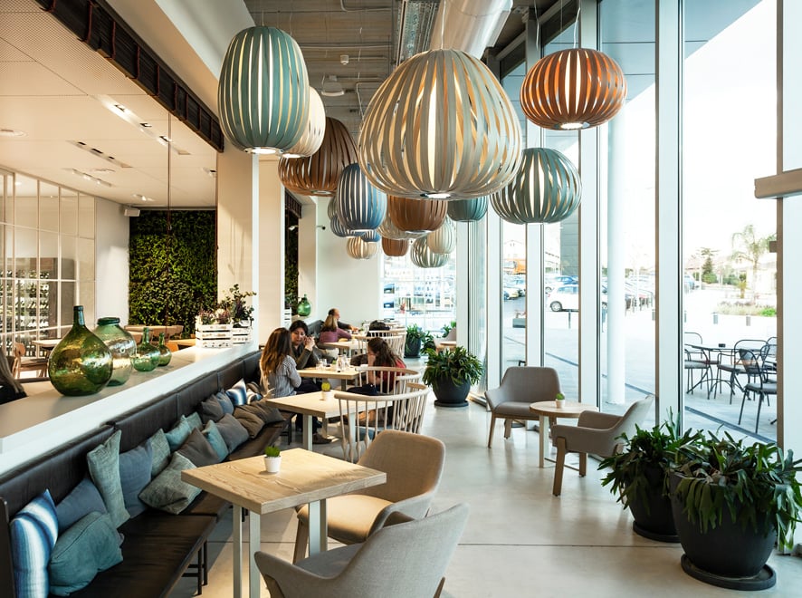 an eye catching cluster of wood veneer lights decorating a restaurant ceiling