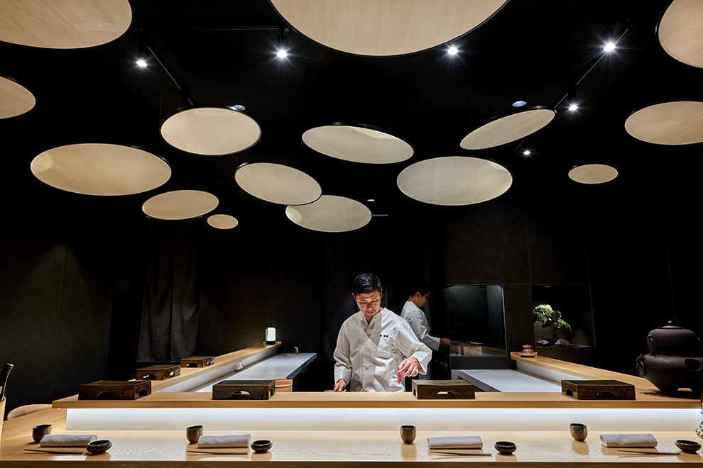 Spectacular Japanese restaurant ceiling decoration with natural wood circular panels hung at an angle