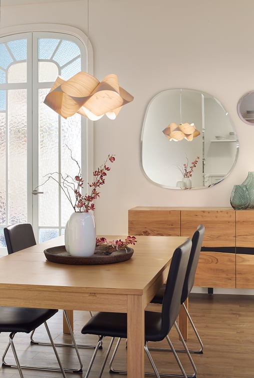 Cozy dining room with a three dimensionally turned wood veneer lamp