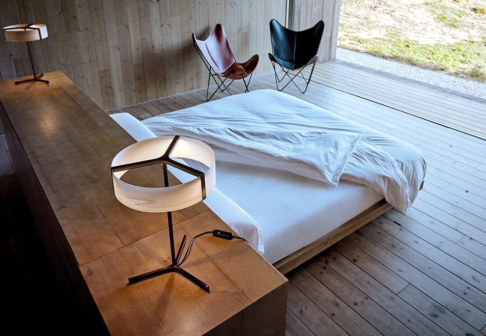 Bedroom of the house of the architect Ramon Esteve with his metal and wood veneer table lamps designed for LZF