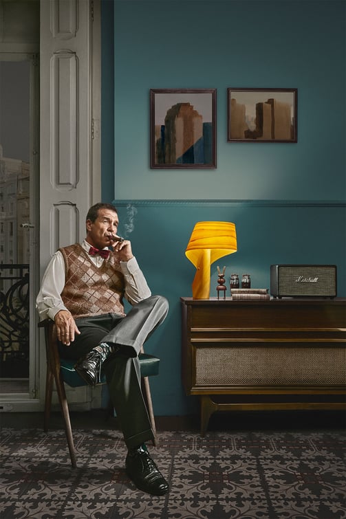 Nelson smoking a cigar on his armchair. LZF Air table lamp.