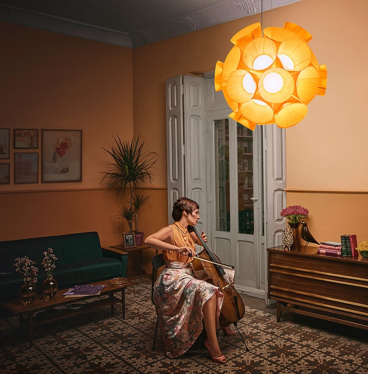 Lana with her cello. Dandelion suspension lamp