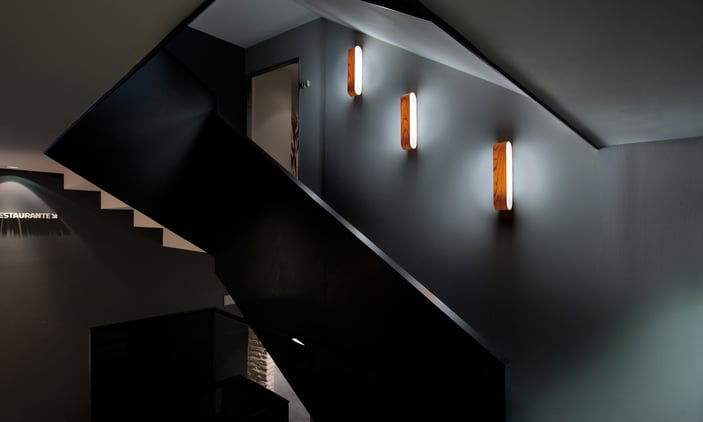 Cherry wood-wall-lamps-lighting-up-a-staircase-in-a-hotel