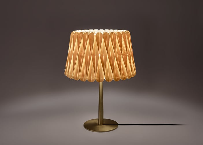 Small table-lamp-with-golden-metal-base-and-geometric-pattern-of-natural-wood-veneer
