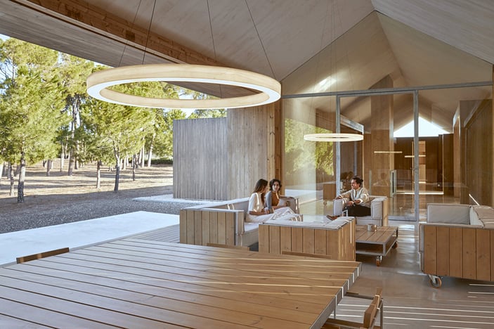 House with-open-space-with-ring-shaped-lamps-made-of-wood-veneer-and-light-diffuser