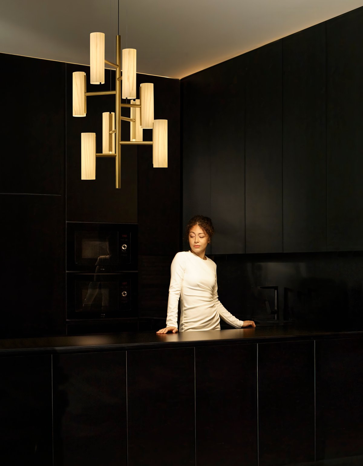 elegantly illuminated-kitchen-with-the-Black-Note-Chandelier-design-by-Ramón-Esteve-made-of-wood-veneer-and-metal
