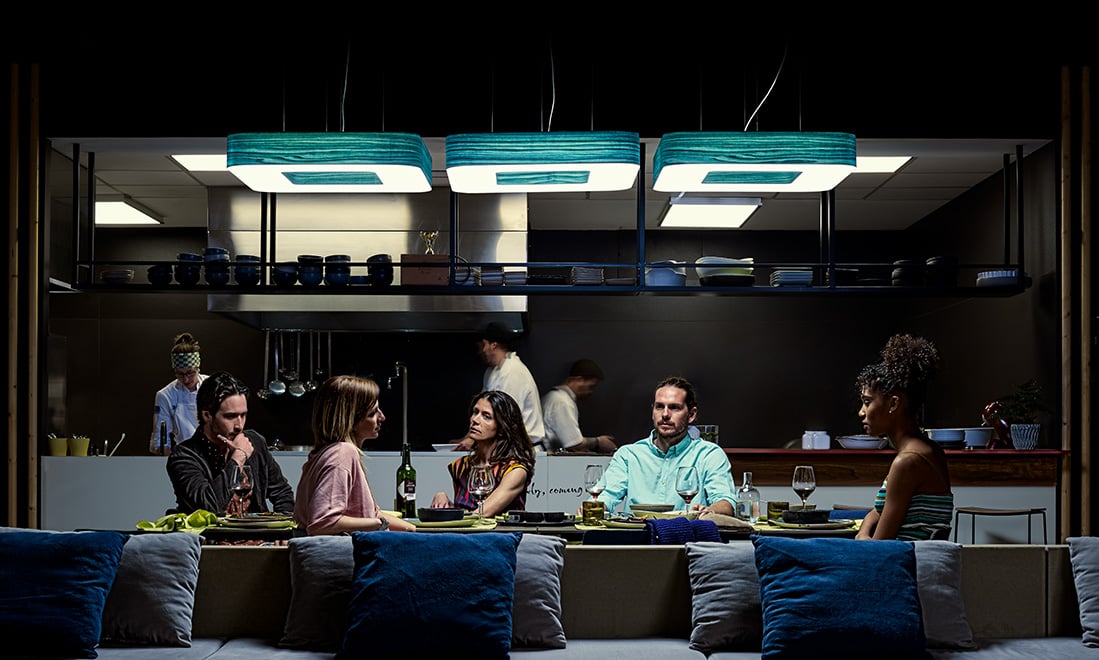 People dining-at-a-restaurant-table-illuminated-by-LZF's-Cuad-wooden-lamps