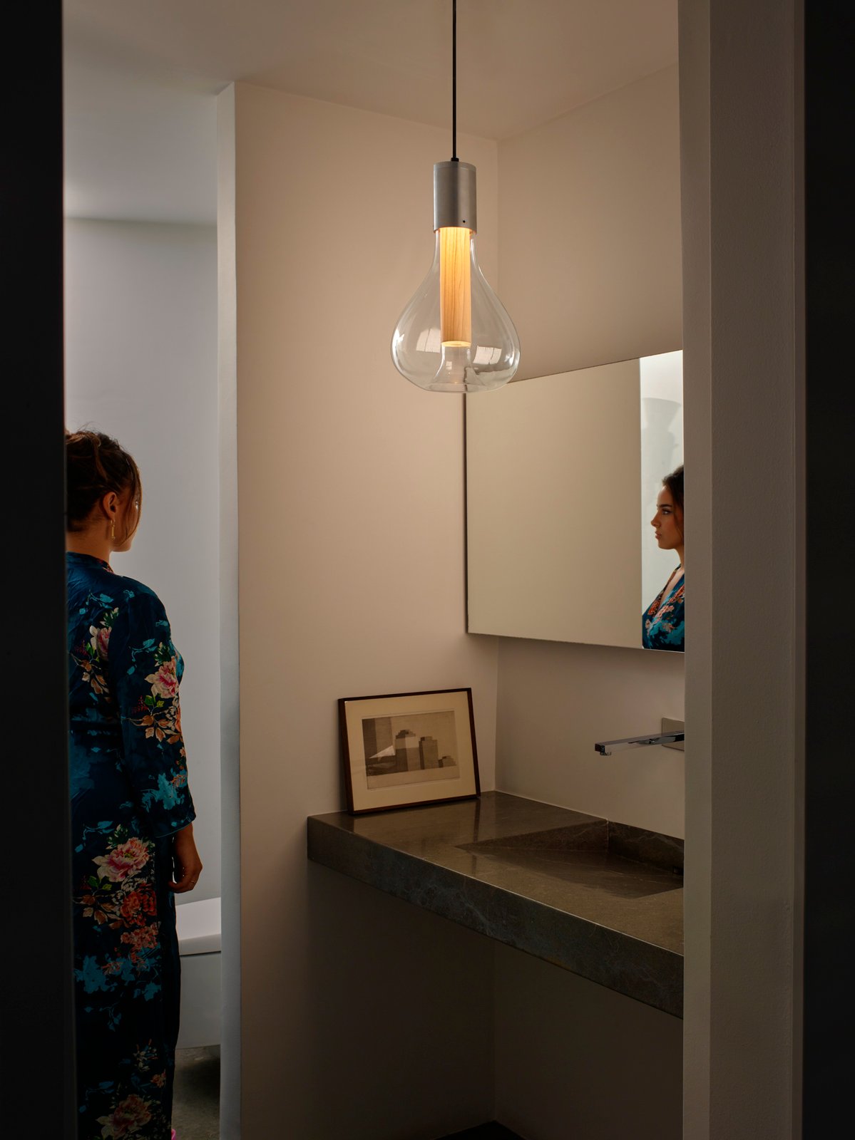 bathroom illuminated-with-the-Eris-lamp-by-lzf-lamps-that-provides-a-soft-and-pleasant-atmosphere-with-its-glass-paired-with-wood