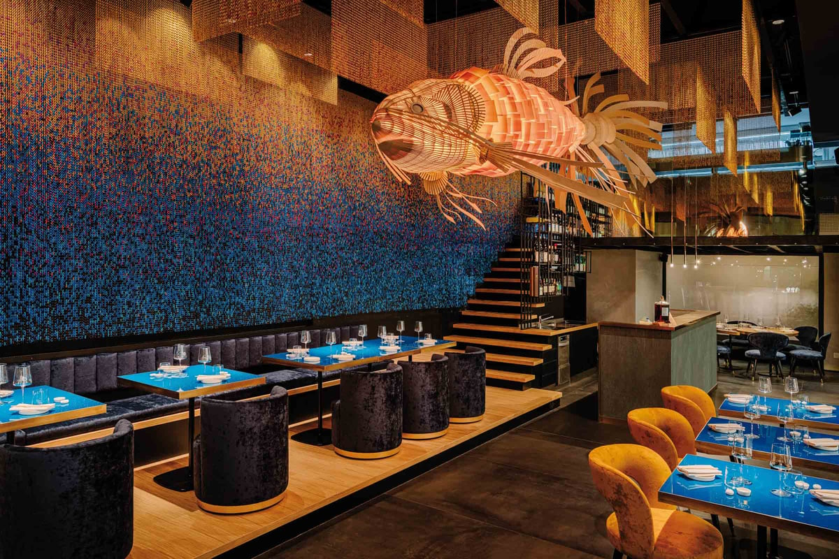 large koi-sculptural-lamp-suspended-in-the-centre-of-a-restaurant