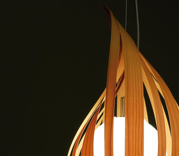 Detail of-suspension-lamp-made-of-wood-veneer-strips-in-the-shape-of-a-drop-and-containing-a-shiny-ball-inside