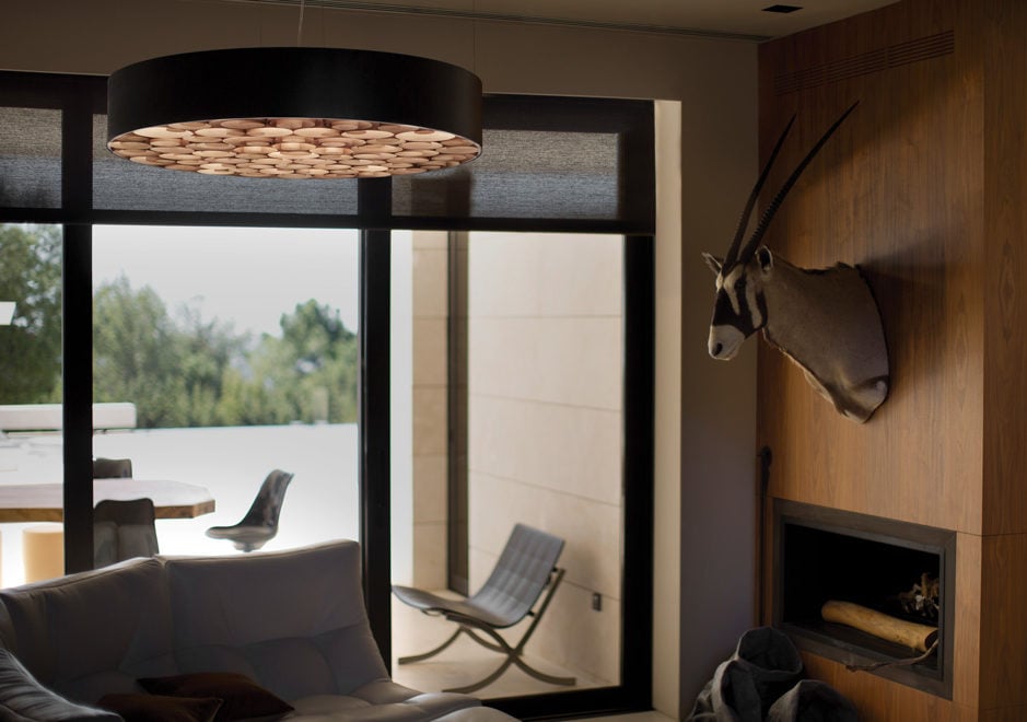 Living room-presided-over-by-an-impressive-circular-suspension-lamp-whose-frame-contains-a-mass-of-irregular-spirals-of-wood-veneer